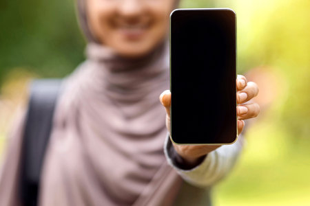 Muslim girl showing blank newest smartphone screen