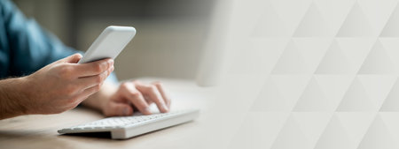 Unrecognizable businessman working with smartphone and computer in office, closeupの写真素材
