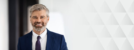 Portrait Of Handsome Smiling Middle Aged Businessman Wearing Suit Looking At Camera
