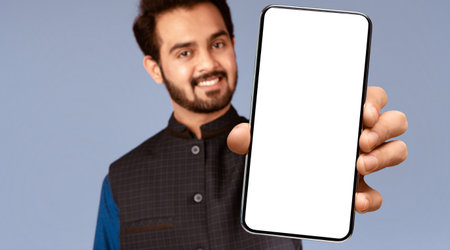 Smiling Indian guy showing thumb up on violet background, selective focusの写真素材