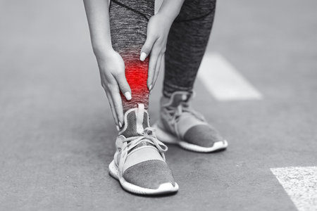 Leg Injury. Unrecognizable Woman Massaging Inflamed Shin Zone With Red Sore Spot