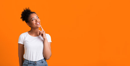 Portrait of black girl looking up at studio