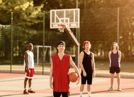 Asian basketball player with team ready to play match at outdoor arenaの写真素材
