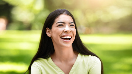 Portrait Of Beautiful Asian Girl Sincerely Laughing Outdoors, Enjoying Day In Parkの写真素材