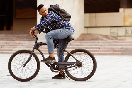 Portrait of black guy riding his bike in the cityの写真素材