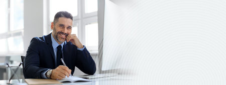 Businessman working diligently in a modern office with a positive demeanorの写真素材