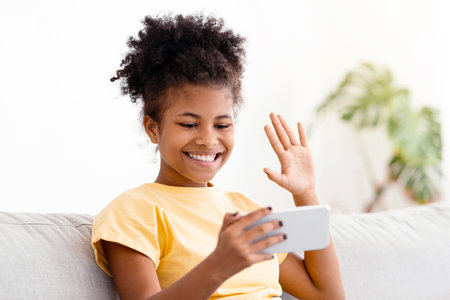 African Teen Girl With Smartphone Making Video Call At Home