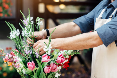 Small business, male florist focused on composition in flower shopの写真素材