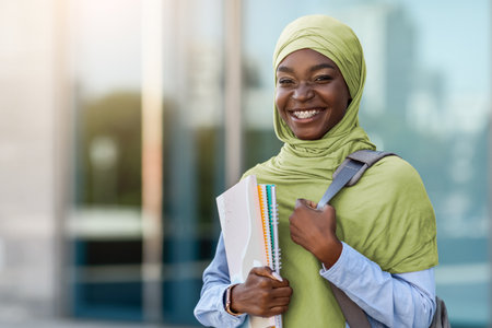 College Scholarships for Muslim Students. Happy Black Islamic Woman With Workbooks Outdoorsの写真素材