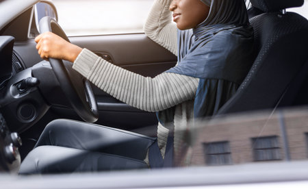 Tired African Muslim Lady Driving Car, Having Headache And Feeling Sleepy
