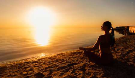 Woman sitting in lotus pose and meditatingの写真素材
