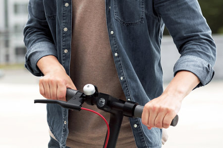 Guy riding motorized kick scooters in the cityの写真素材