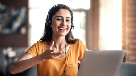 Positive young woman having videochat with friends