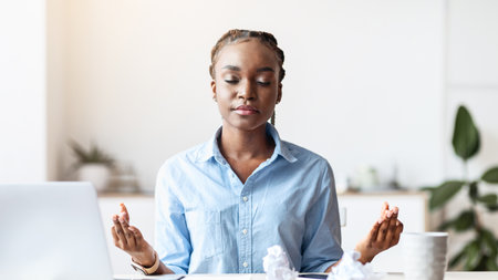 Coping With Stress At Work. Young African Businesswoman Meditating In Officeの写真素材