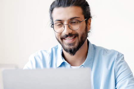 Recruitment Concept. Smiling Eastern Guy Using Laptop, Searching Jobs Online In Internetの写真素材