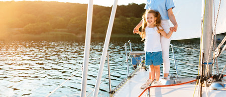 Mother And Daughter Posing Holding Hands Standing On Sailboat Deckの写真素材