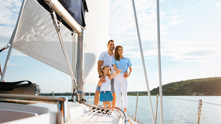 Family Relaxing On Yacht Enjoying Boat Ride Standing Outdoor, Panoramaの写真素材