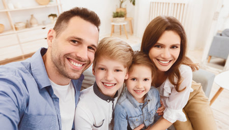 Happy Parents And Children Smiling Posing To Camera At Homeの写真素材