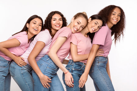 Cheerful Multiethnic Women Hugging Posing Over White Studio Backgroundの写真素材