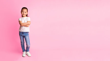 Smiling asian girl posing and looking at cameraの写真素材