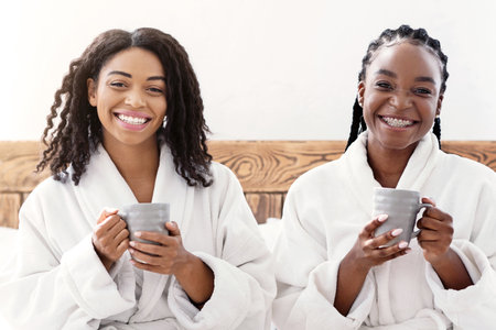 Two black girlfriends having beauty day on weekendの写真素材