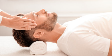 Bearded man enjoying relaxing head massage at spaの写真素材