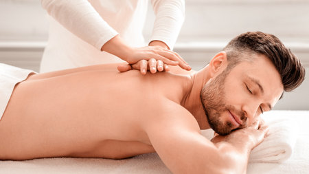 Relaxed man having manual therapy session at spaの写真素材