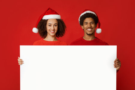 Christmas couple holds white board with copy space and advertise New Year season shopping sale conceptの写真素材