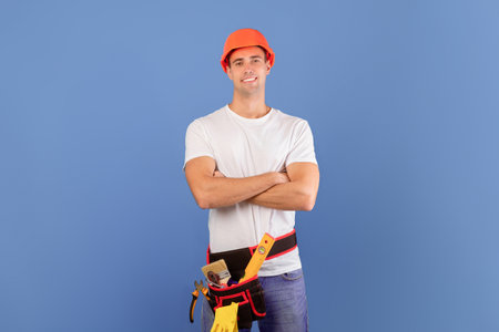 Confident young couple in hard hats ready for house repairment and renovation