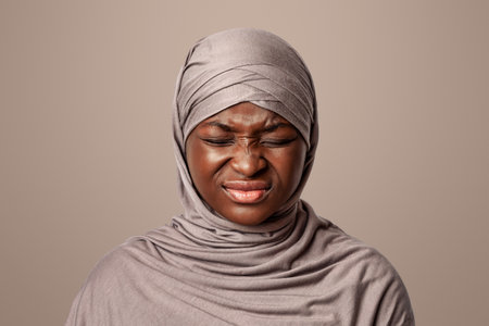 Irritated Black Muslim Lady In Hijab With Displeased Face Expression