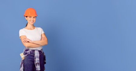 Repairment Budget Planning. Portrait Of Man And Woman Repair Masters In Helmetsの写真素材