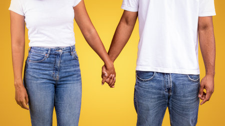 African American Couple In Santa Hats Holding Hands, Studio Shot