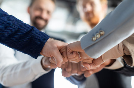 Business Team Fist Bumping in Office Setting, Croppedの写真素材