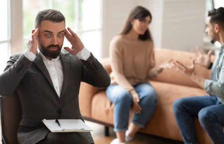 Couple arguing at therapy session, male therapistの写真素材