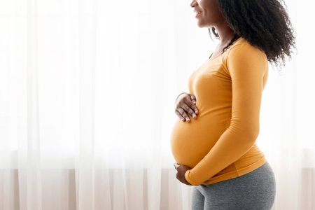 Black expecting lady looking at copy spaceの写真素材