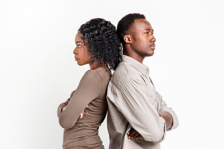 Frustrated african american couple posing on grey