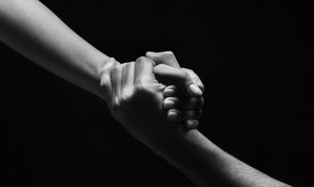 Unrecognizable woman hand helping man to stand upの写真素材