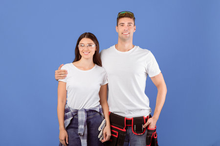 Repair Concept. Portrait Of Young Couple With Safety Glasses And Construction Belt