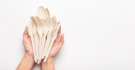 Woman holding in hands set of biodegradable single use cutleryの写真素材