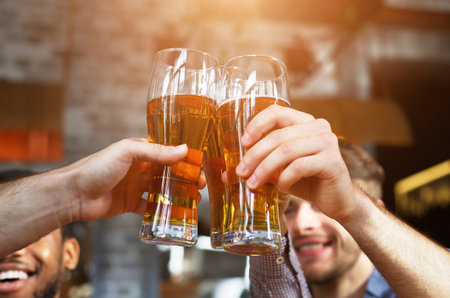 Cheers For Us. Men Drinking Draft Beer And Clinking Glassesの写真素材