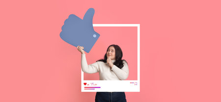 Influencer gives a big thumbs up against a pink backdrop