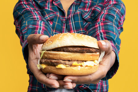 Funny African American Lady Giving Burger At Studioの写真素材