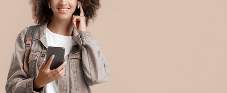 Musical pause and modern gadgets. Smiling attractive young african american female holds phone