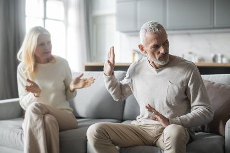 Couple discussing their relationship issues in a modern living room settingの写真素材