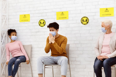 Man With Pneumonia Coughing Sitting With Patients In Hospital