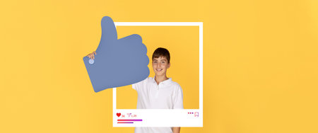 Young boy gives thumbs up for social media content with bright background