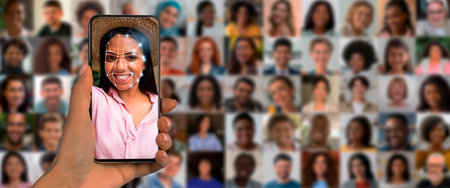 Modern facial recognition technology displayed on smartphone with multiple facesの写真素材