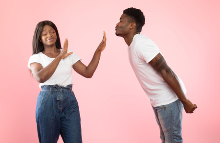 Man trying to kiss disgusted woman rejecting him