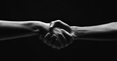 Woman and man handshaking on black background