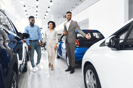 Seller Showing Luxury Car Consulting Couple In Dealership Shopの写真素材